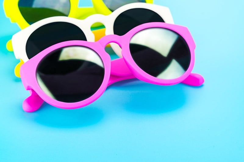 Bright Color Palettes - Photo of bright sunglasses on blue background