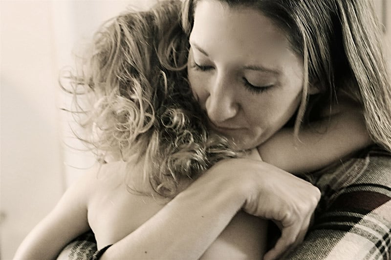 Monochromatic photo of mother and daughter hugging