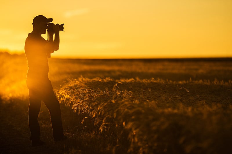 Landscape photographer at sunset